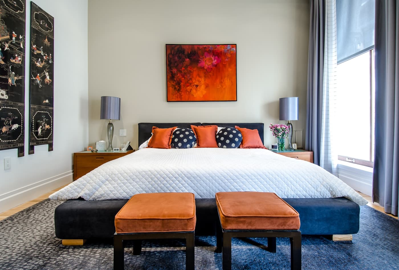 Guest bedroom with an immaculately made bed and pressed white linen